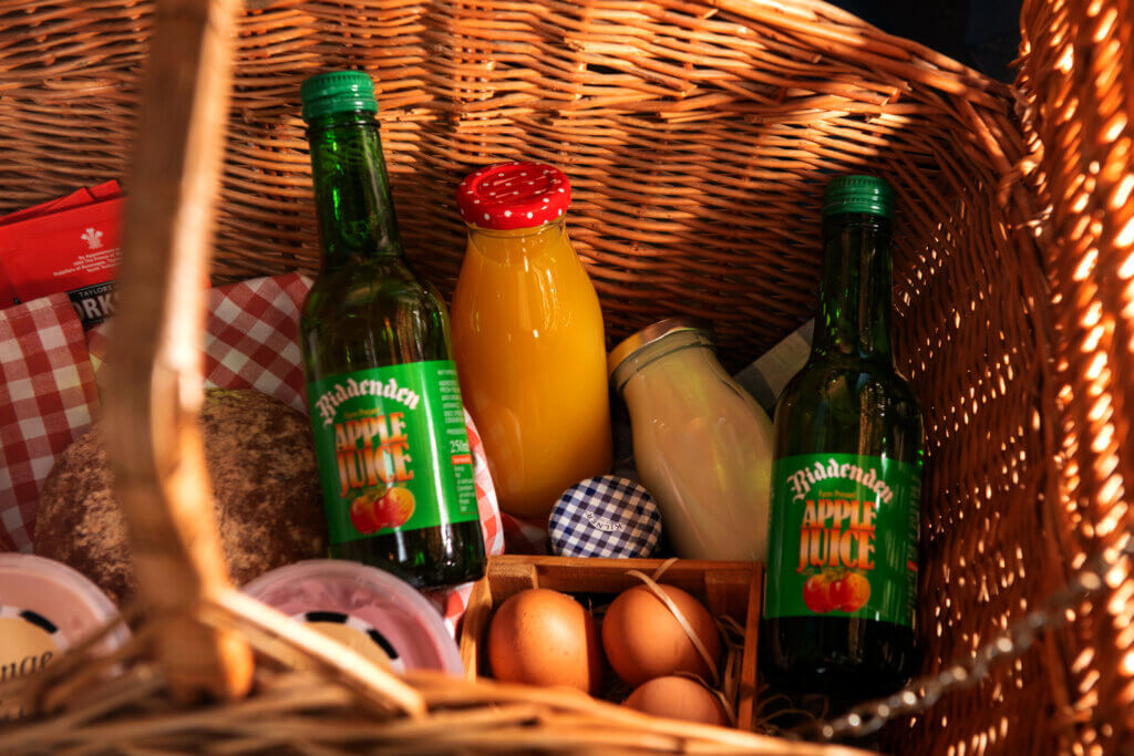 Picnic basket with apple juice, eggs, milk